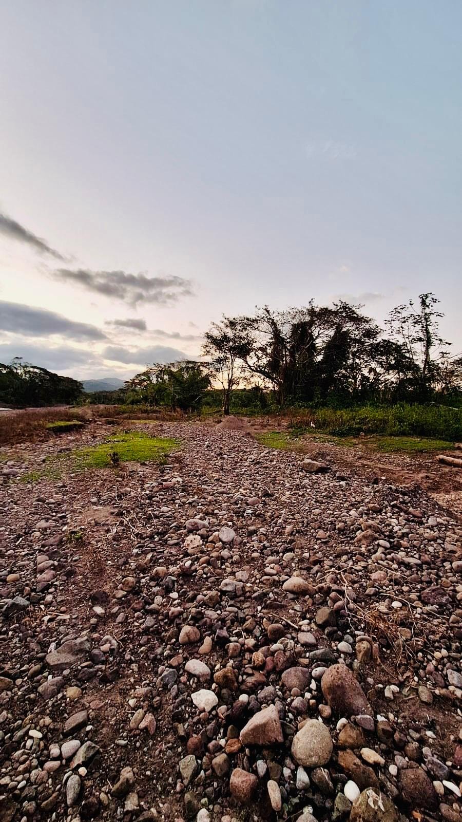 Gravel and stone stockpiles as they appeared during prior quarry operations — Rio Minho valley