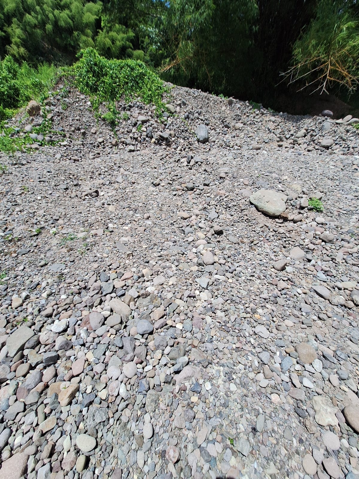 Crushed stone and river gravel stockpiles during the active quarry period — Morgan's Pass