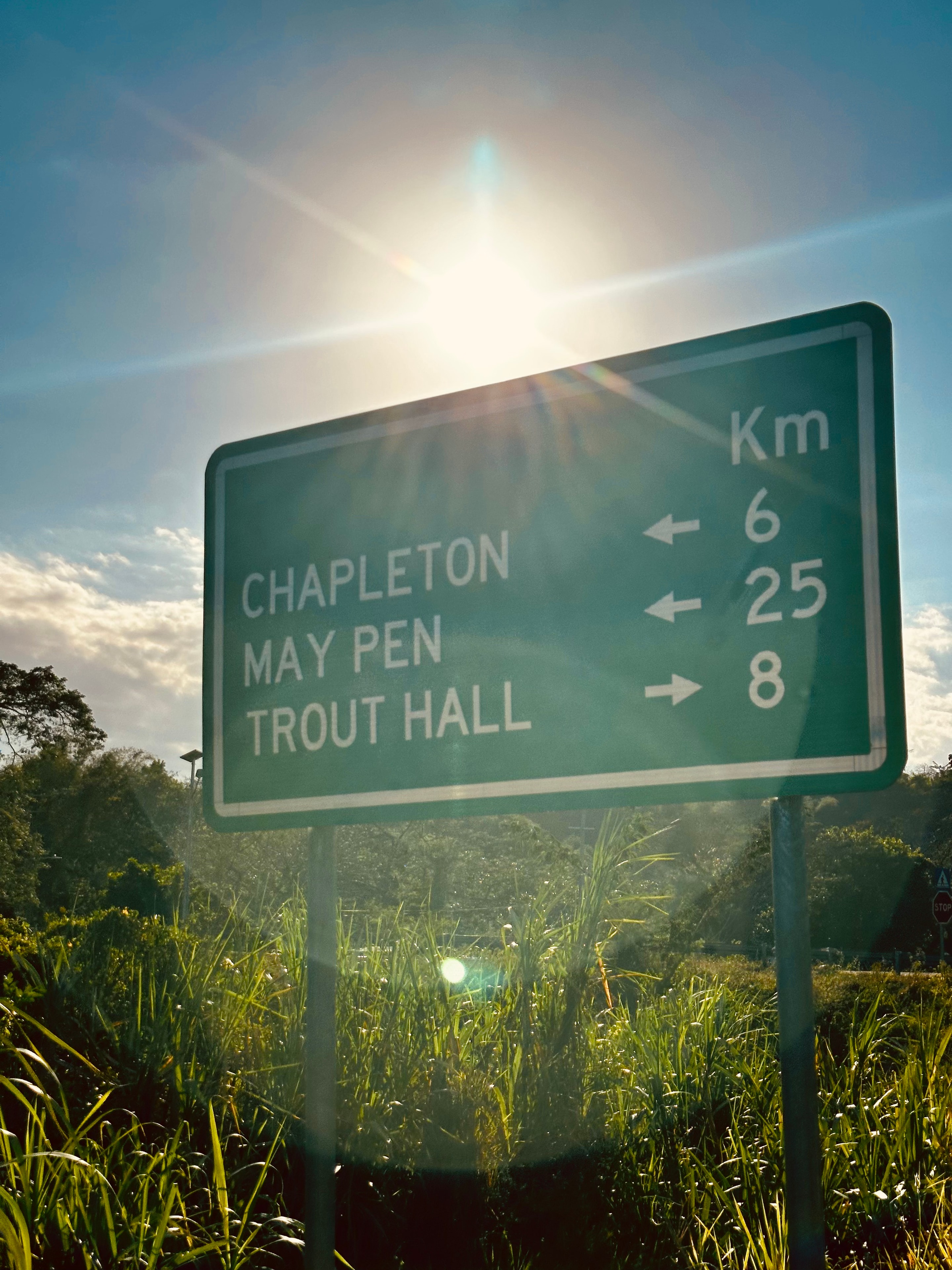 Road sign near Morgan's Valley showing distances to Chapleton, May Pen and Trout Hall