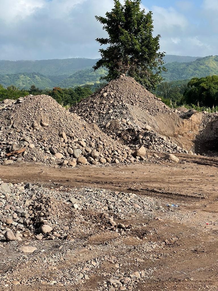 Aggregate stockpiles with Clarendon hills backdrop — historical photo from active quarry period